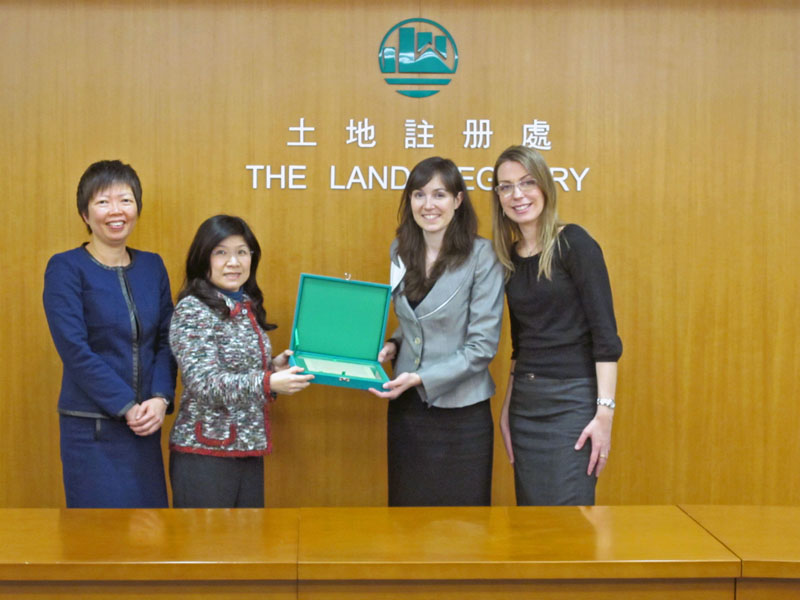 The Land Registrar, Ms Olivia Nip (second from left) presents a souvenir to the representatives of the World Bank