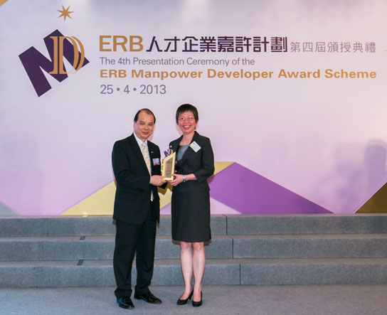 Hon. Matthew Cheung Kin-chung, GBS, JP, Secretary for Labour and Welfare (left) presents the ERB Manpower Developer Award to Mrs Amy Fong, The Registry Manager