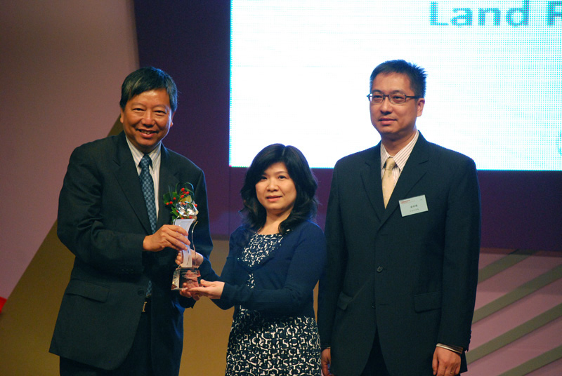 The Legislative Council Member, Mr Lee Cheuk-yan (left) presents the trophy for the First Runner-up of Service Enhancement Award (Small Department Category) to the Land Registrar, Ms Olivia Nip (centre)