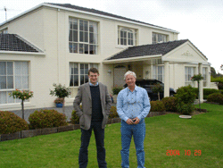 The Land Registrar with Mr. A G Cooper outside Mr. Cooper's new house in Melbourne