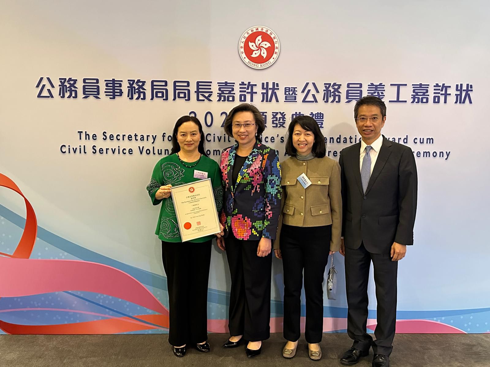 The Secretary for the Civil Service, Mrs YEUNG HO Poi-yan, Ingrid, JP (second from the left), the Permanent Secretary for the Civil Service, Mr Clement LEUNG, JP (first from the right) and the Land Registrar, Ms Joyce TAM, JP (second from the right) taking photo with the awardee of The Secretary for the Civil Service's Commendation Award, Clerical Officer of the Land Registry, Ms TING Yuet-ling, Biddy