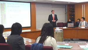 The Land Registrar delivering a welcome speech to students